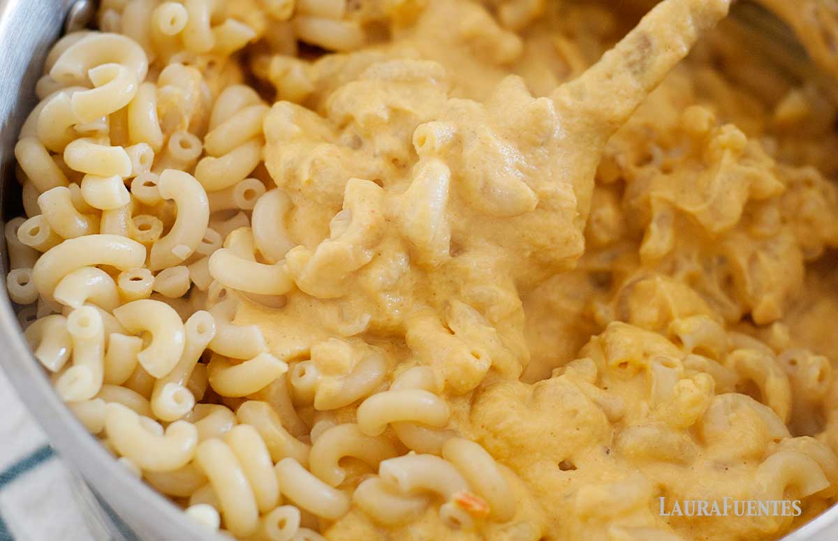 closeup of macaroni and cheese being cooked in a skillet on the stove