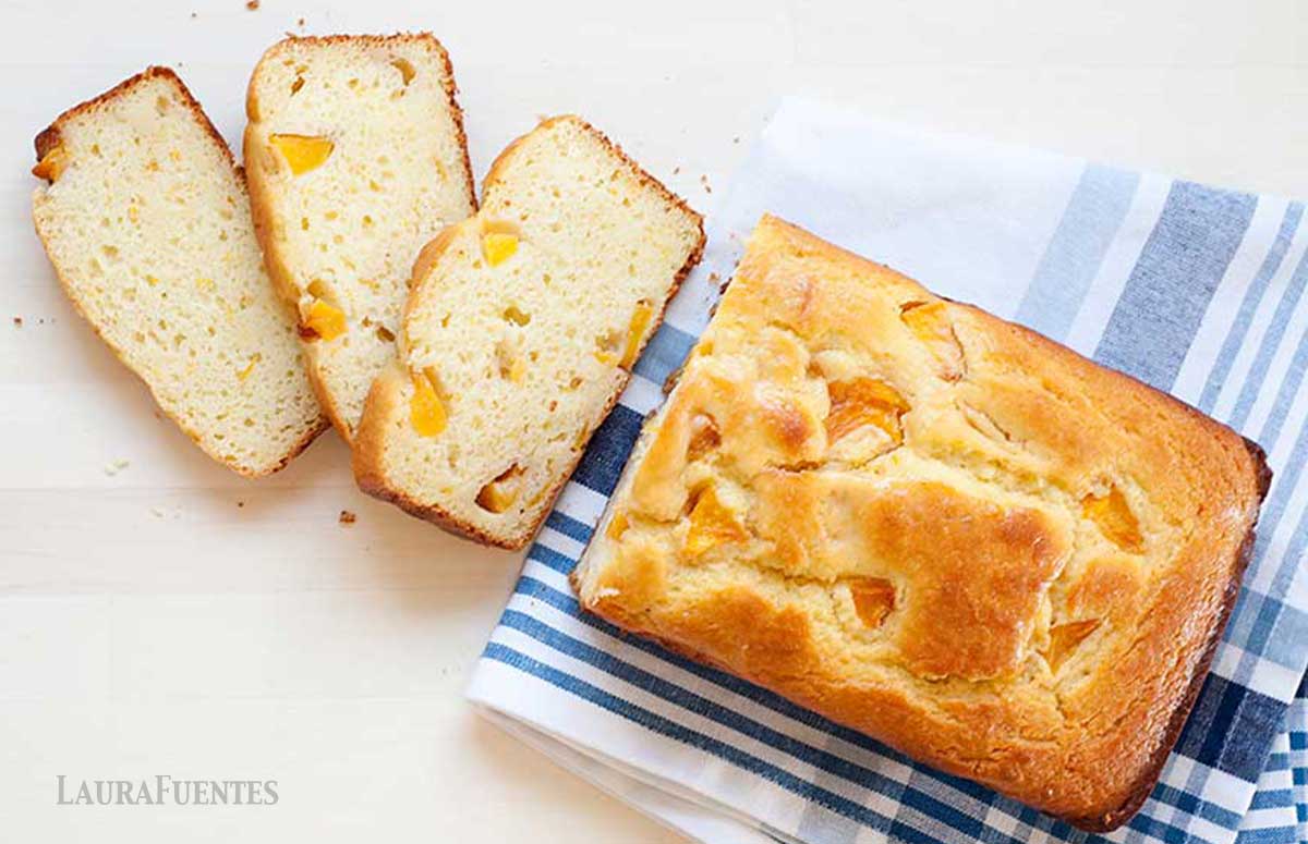 loaf of peach bread with three slices cut