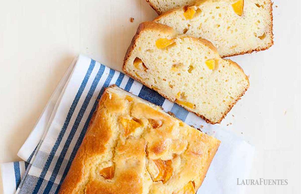 closeup of a loaf of peach bread with two slices