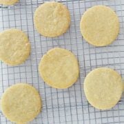 six round sugar cookies on a cooling rack