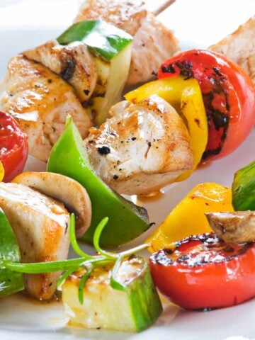 closeup of chicken kabobs on a plate