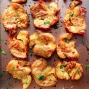 nine smashed potatoes on a baking sheet