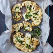 roasted cauliflower steaks in a lined baking dish