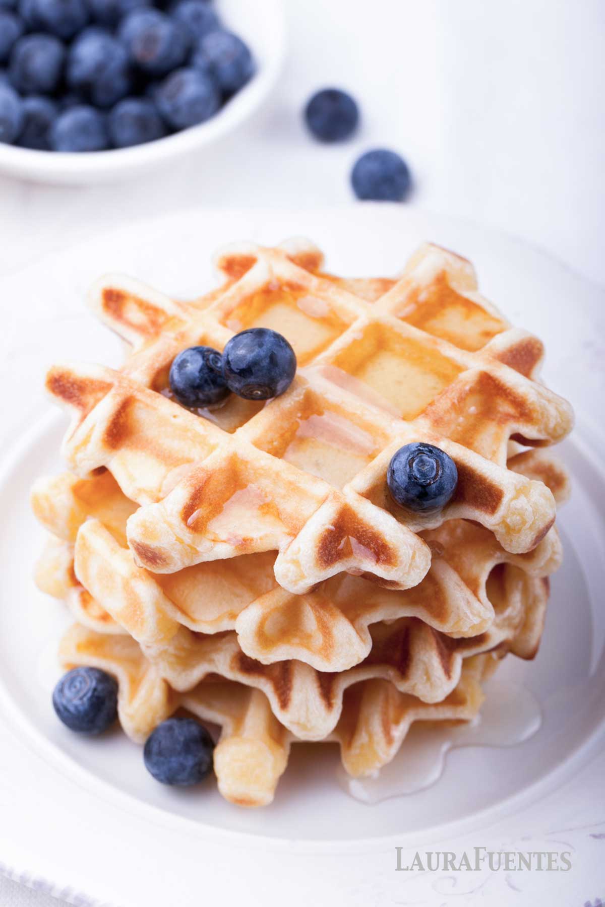 small stack of waffles topped with blueberries