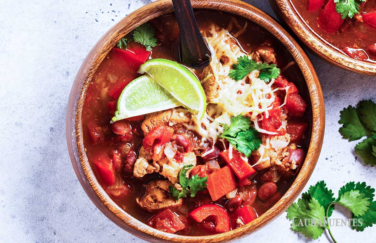 closeup of a bowl of turkey chili topped with sliced limes