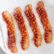 four slices of crispy bacon on paper towels