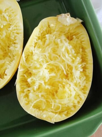 closeup of microwaved spaghetti squash in a green dish