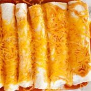rotisserie chicken enchiladas in a pan with melted cheese on top