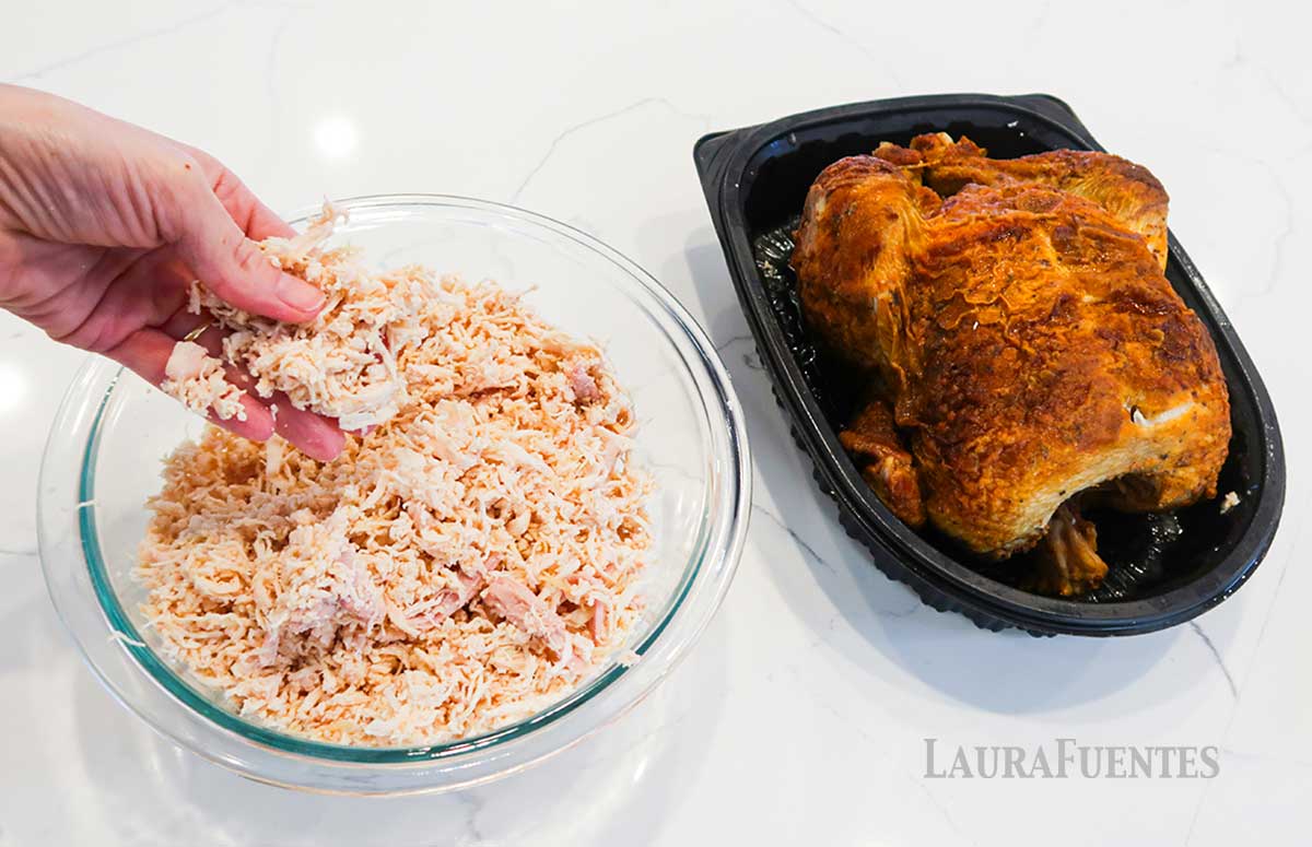 shredded chicken on a bowl and a whole chicken on the side