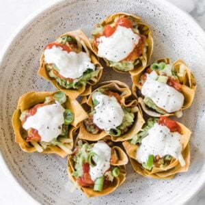 a plate with seven taco cupcakes