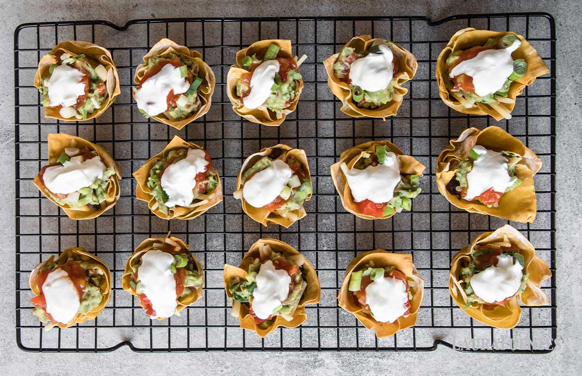 fifteen taco cupcakes on a cooling rack