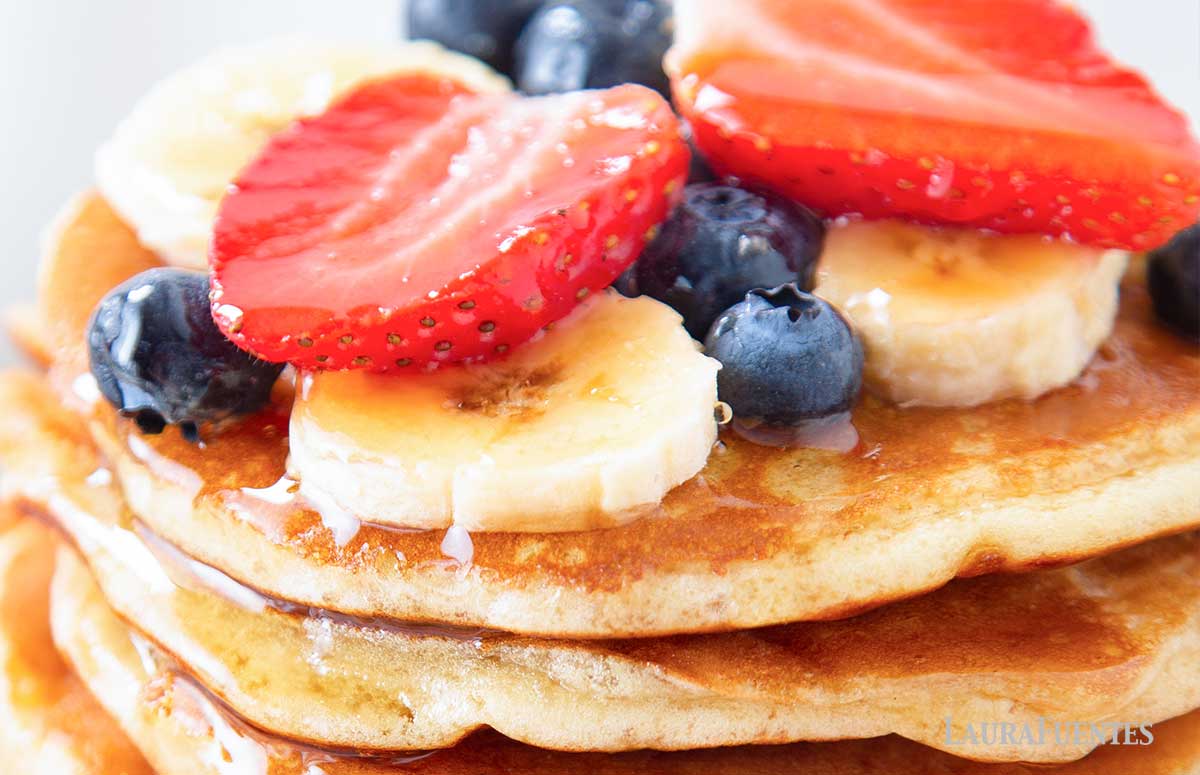 closeup of the fruit toppings on a stack of pancakes