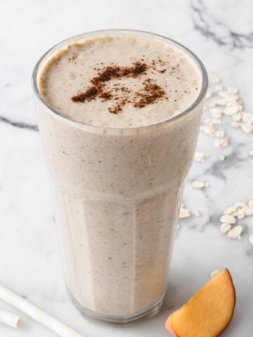 a glass of oatmeal peach smoothie