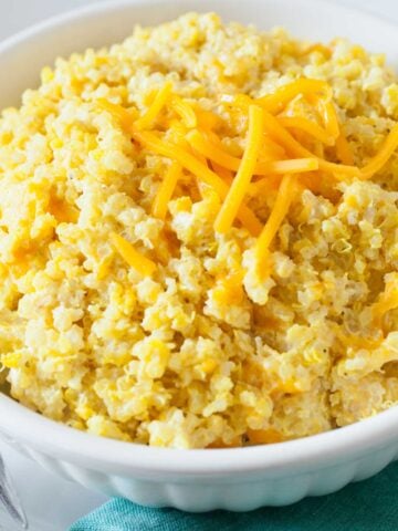closeup of mac and cheese quinoa topped with shredded cheese