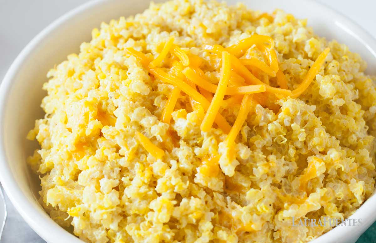closeup of quinoa mac and cheese topped with shredded cheddar cheese