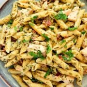 overhead view of a plate with rotisserie chicken pasta with fresh herbs
