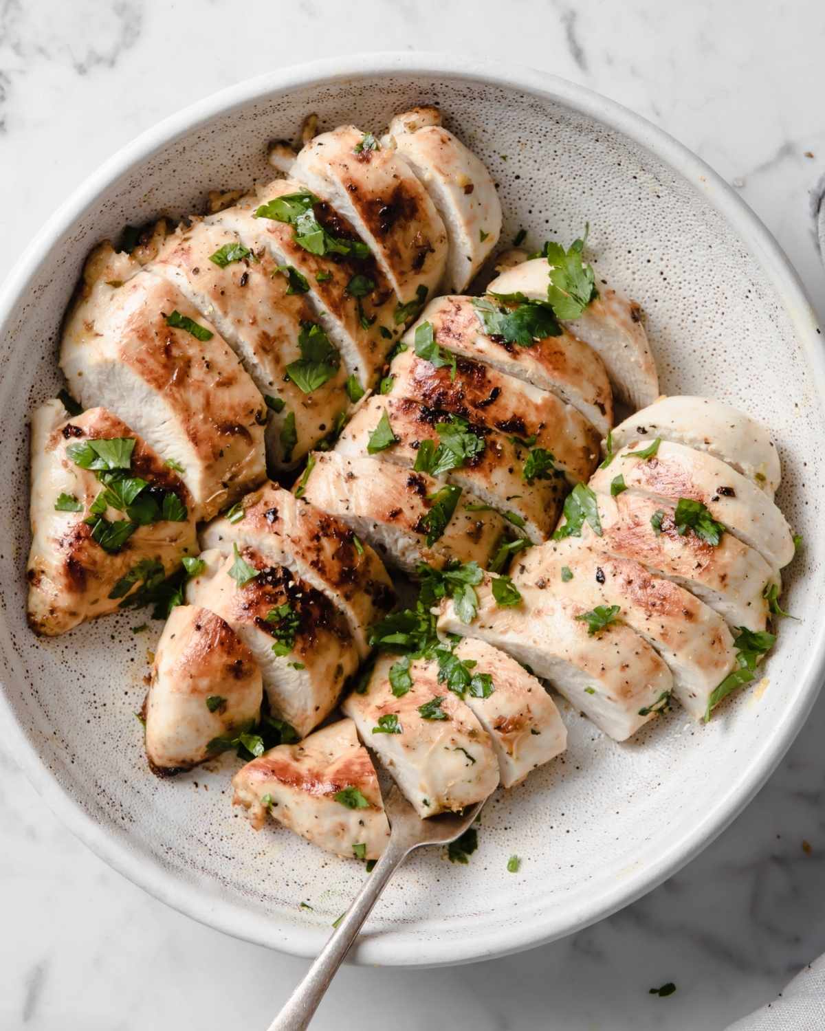 three chicken breasts in a shallow dish