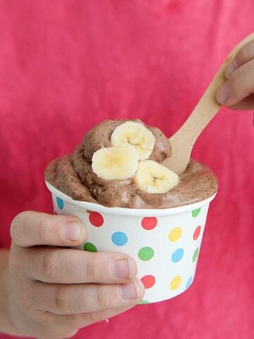 small dish of chocolate ice cream topped with banana slices