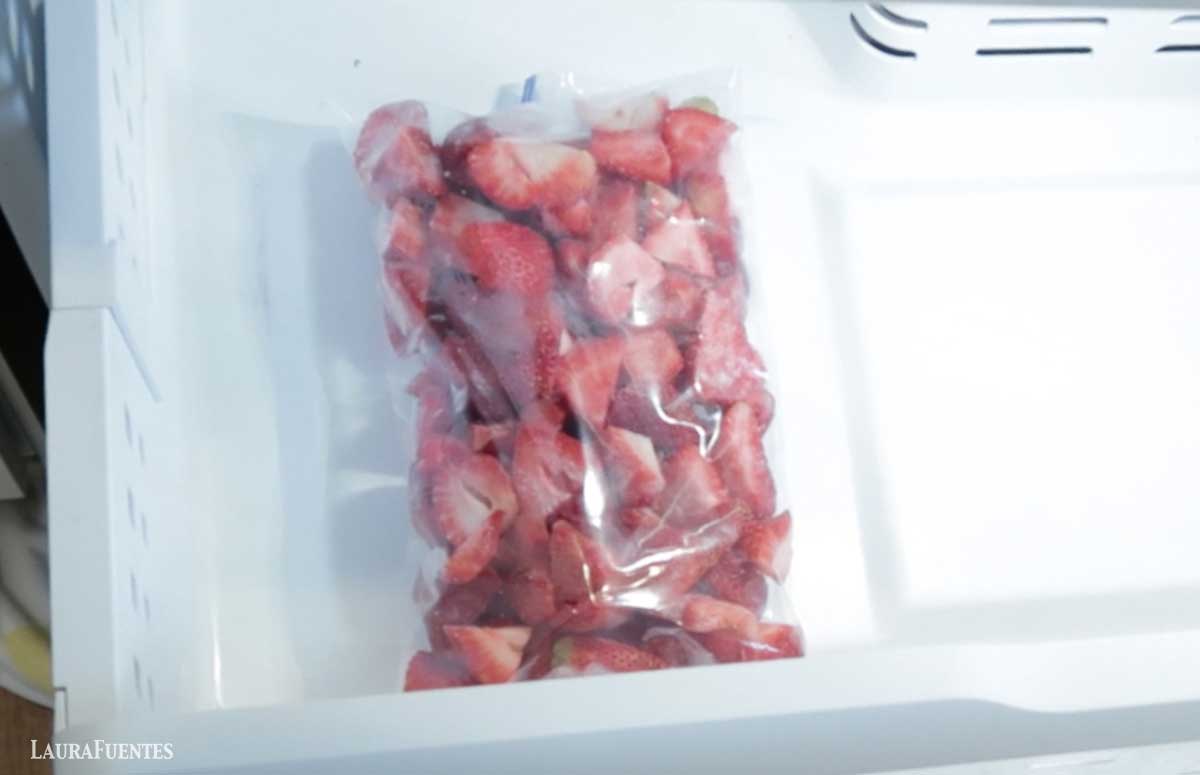 zip bag of frozen strawberries in the freezer