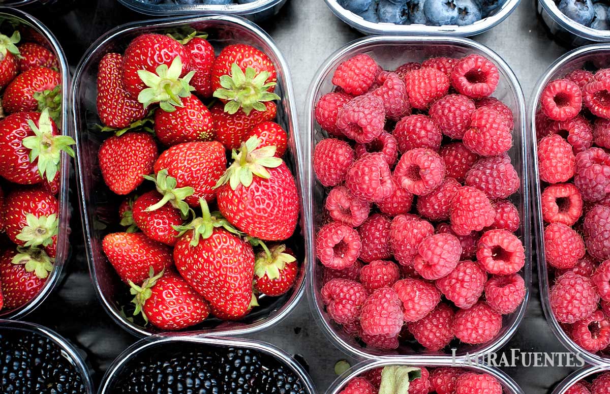 strawberries and raspberries in small boxes