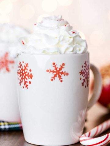 white snowflake mug topped with whipped cream