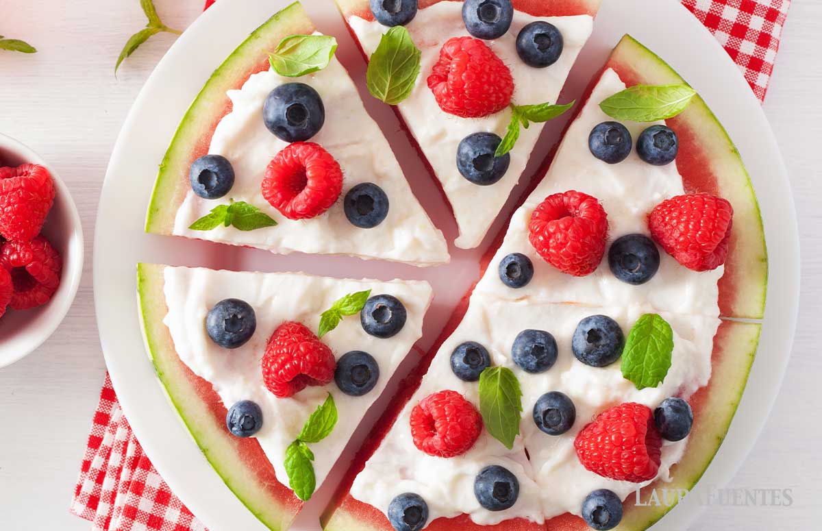 closeup of watermelon pizza topped with fruit and yogurt