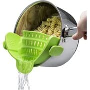 bright green pasta strainer on a pot