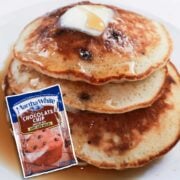 stack of pancakes with a bag of muffin mix in front of the stack