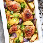 baking dish with roasted chicken pieces and potatoes