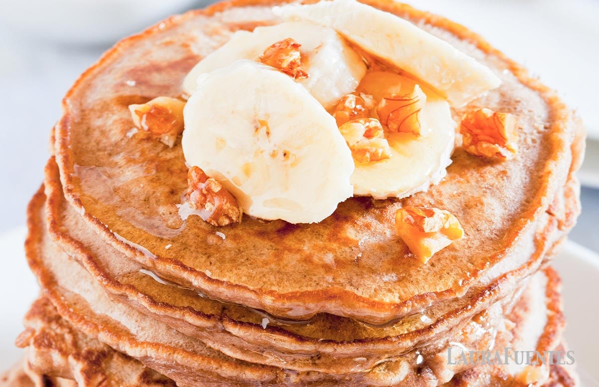 closeup of whole wheat pancakes topped with bananas