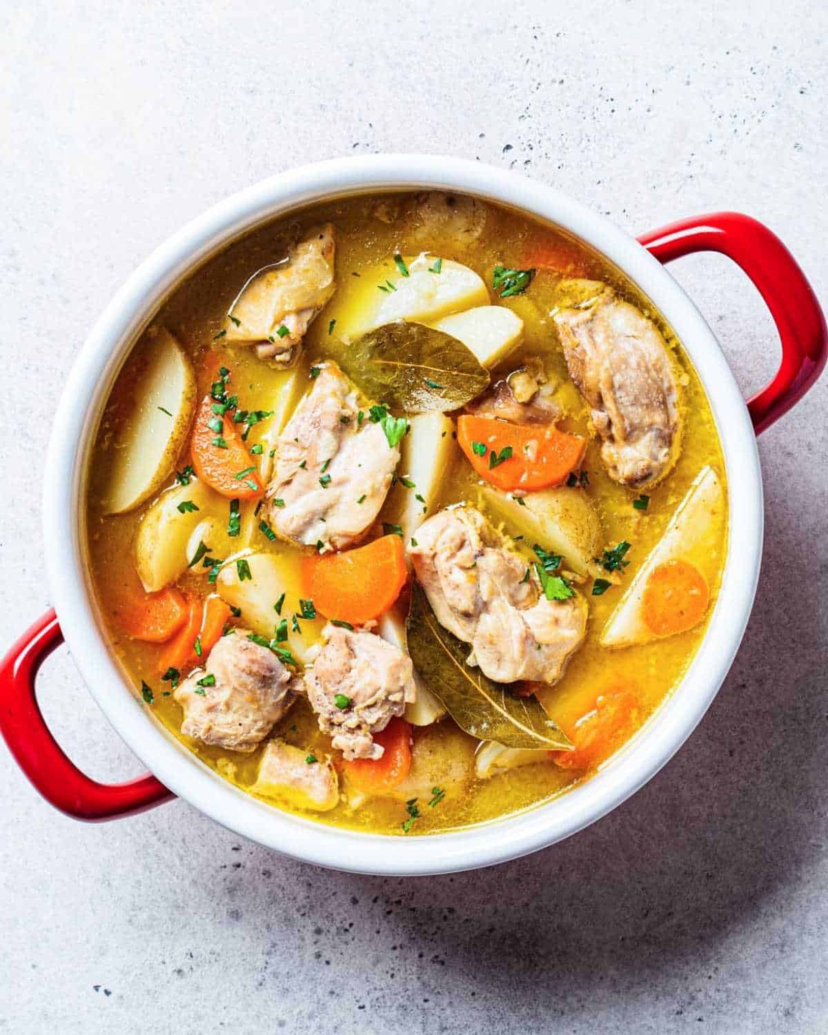 a pot with chicken stew and potatoes