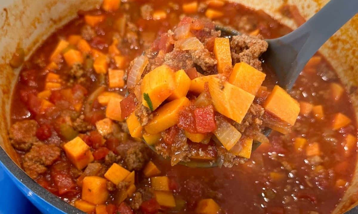 close up of a spoonful of sweet potato chili in a pot