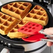 waffle tongs removing a waffle from waffle maker