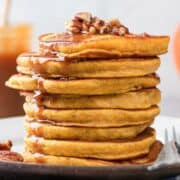 stack of butternut squash pancakes topped with nuts