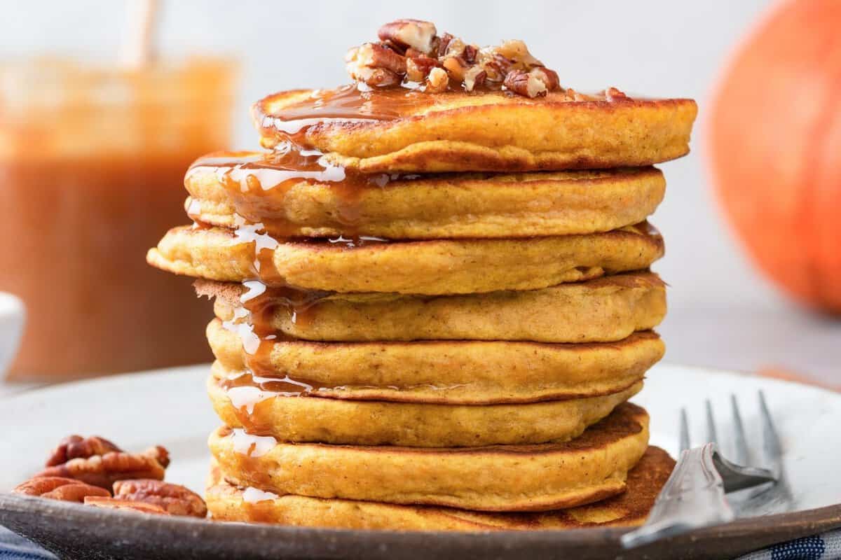 stack of butternut squash pancakes topped with nuts