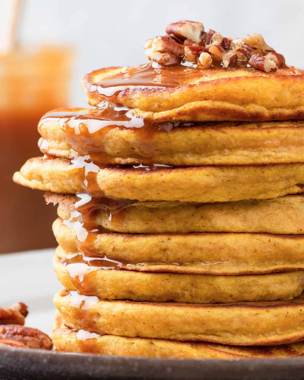 stack of butternut squash pancakes topped with nuts