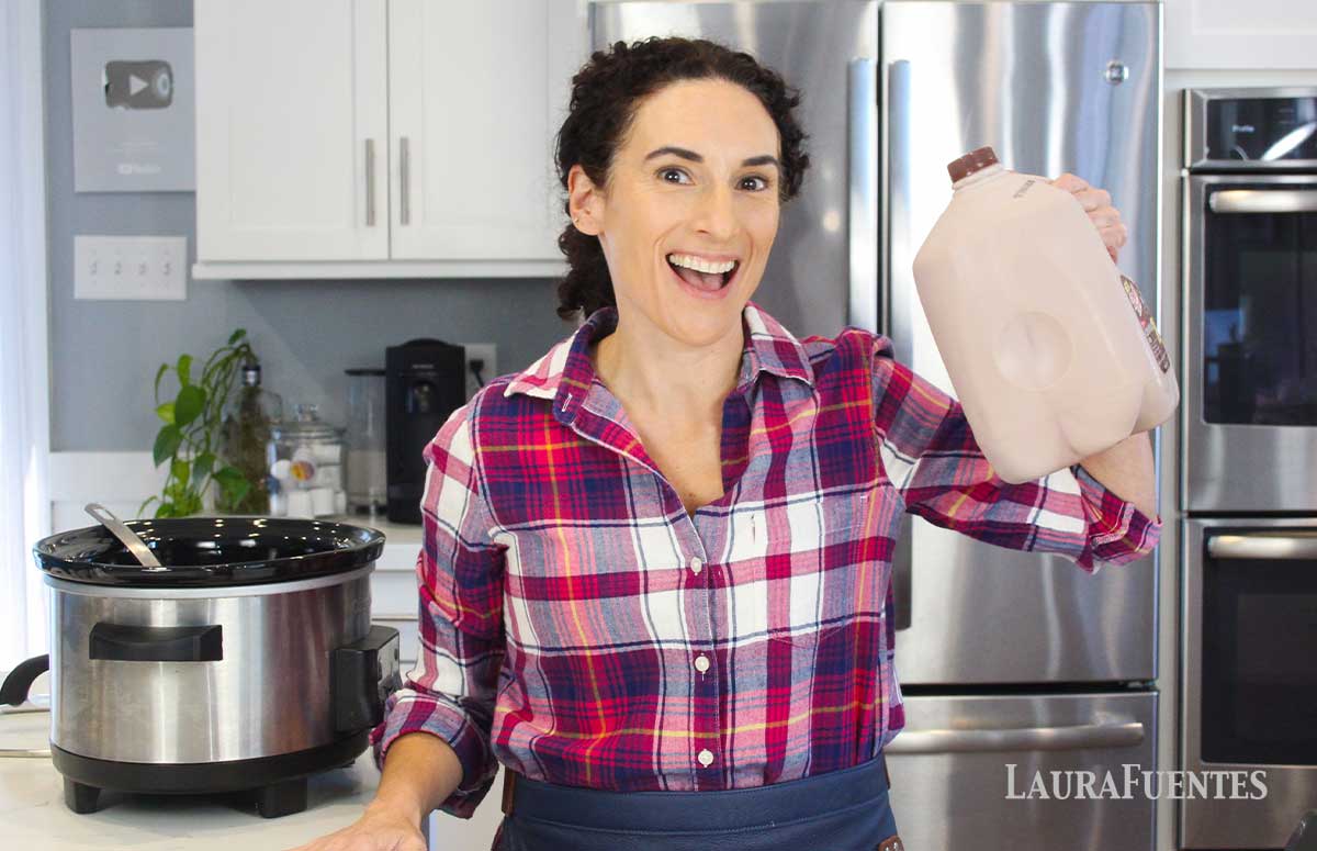 laura fuentes in the kitchen holding a gallon on chocolate milk