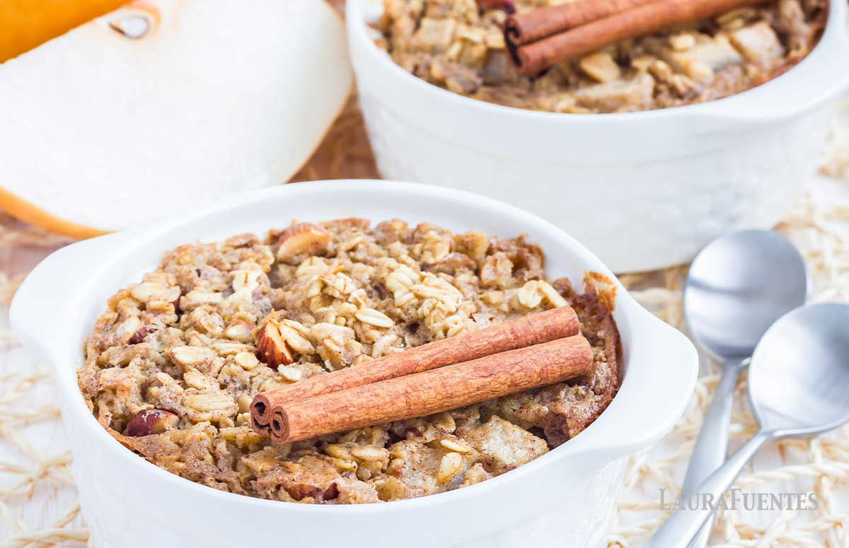 two bowls of baked oatmeal with cinnamon sticks on top
