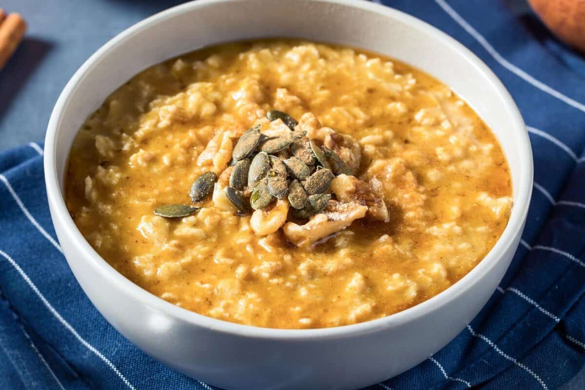 a bowl of sweet potato oatmeal topped with seeds