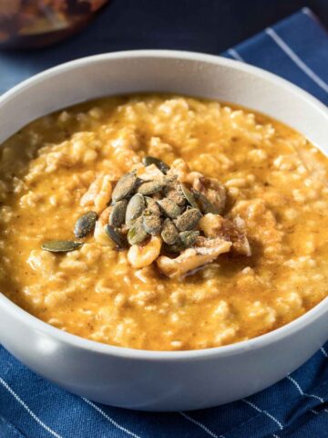 a bowl of sweet potato oatmeal topped with seeds