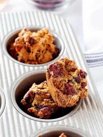 cranberry orange muffins in a muffin tin
