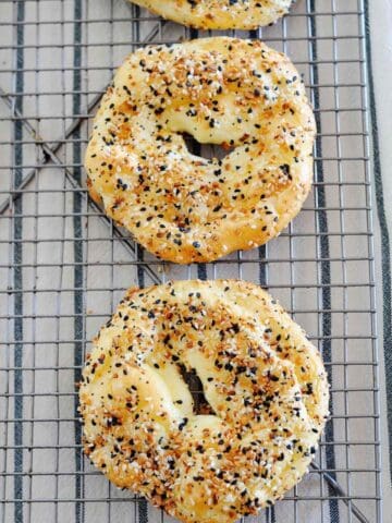 top view of two cloud bread bagel over a cooling rack