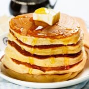 stack of homemade aunt Jemima pancakes with syrup and butter