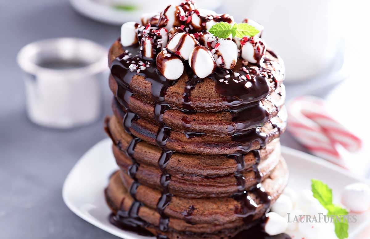 large stack of hot chocolate pancakes on a plate
