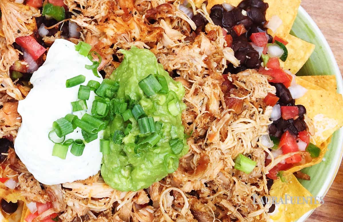 a platter with rotisserie chicken nachos