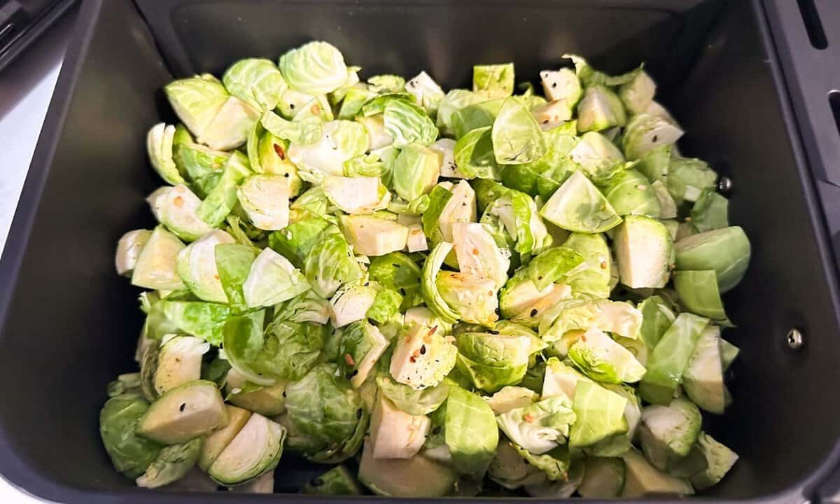 raw Brussels sprouts in an air fryer basket