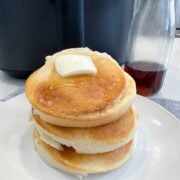 stack of fluffy pancakes in front of an air fryer