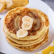 stack of banana bread pancakes topped with banana slices