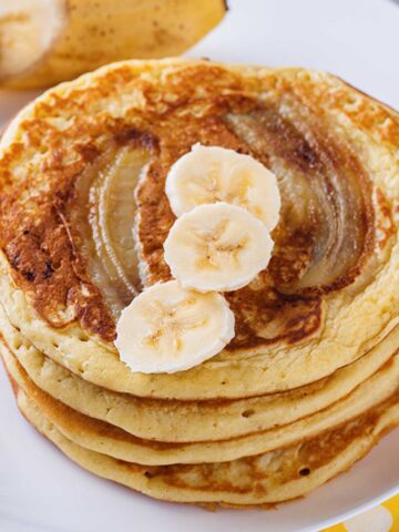 stack of banana bread pancakes topped with banana slices