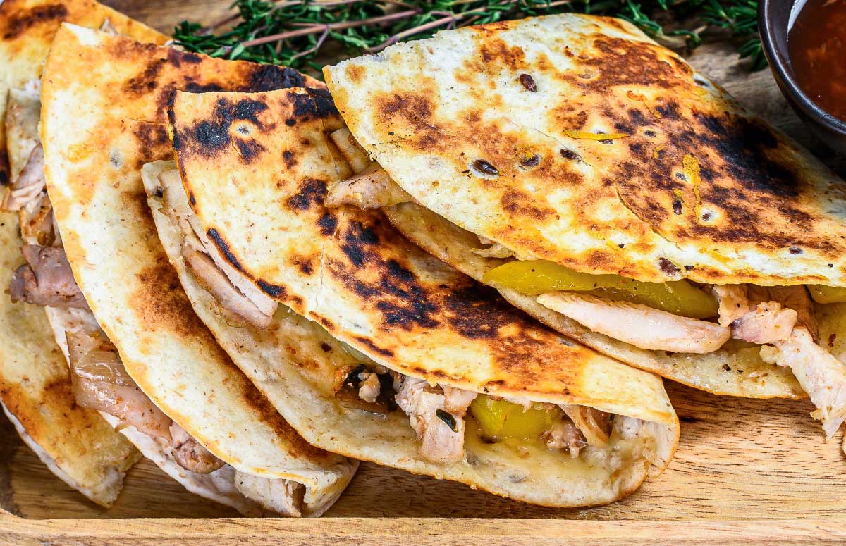 rotisserie chicken quesadillas over a wooden board